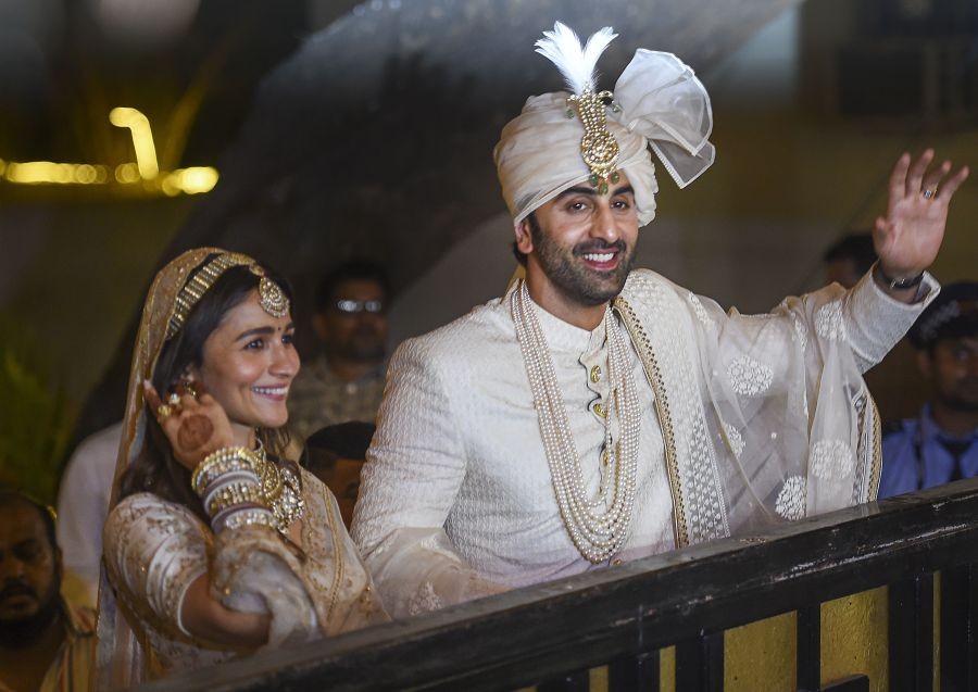 Mumbai: Bollywood actors Ranbir Kapoor and Alia Bhatt pose for pictures after their wedding ceremony, outside their residence, in Mumbai, Thursday, April 14, 2022. (PTI Photo/Kunal Patil)(