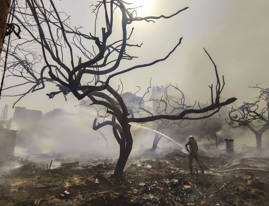 Noida: Firefighters attempt to douse a blaze in a slum area in Noida, Tuesday, April 26, 2022. (PTI Photo)