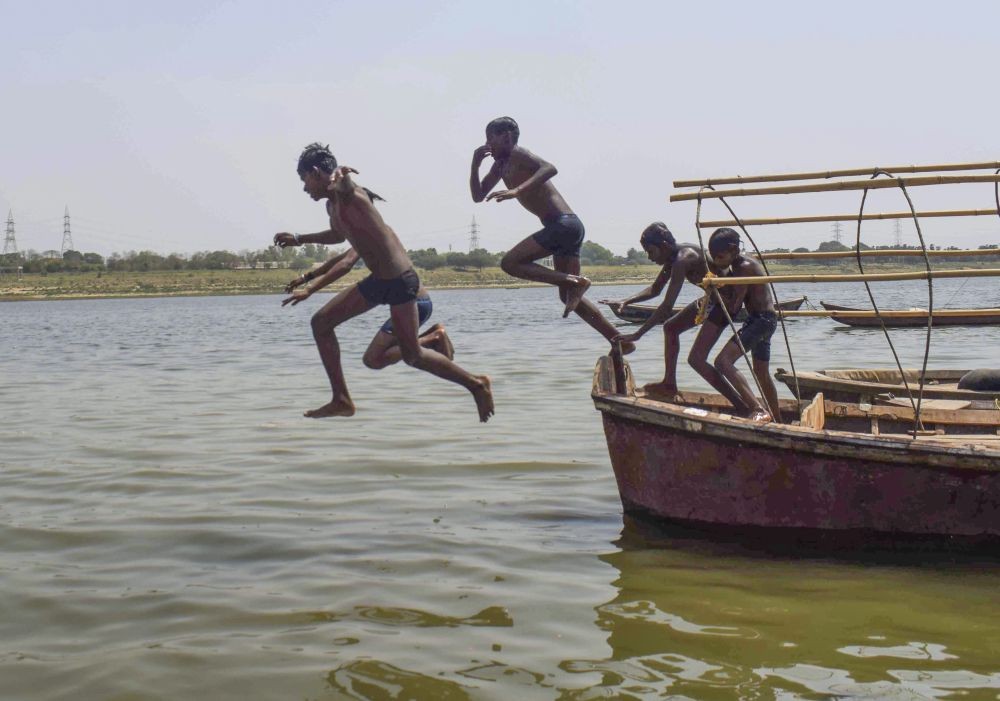 Prayagraj: Youngsters dive into the Yamuna river to beat the heat, during a hot summer day, in Prayagraj, Friday, April 29, 2022. (PTI Photo)(