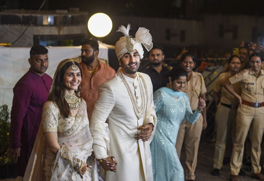 Mumbai: Bollywood actors Ranbir Kapoor and Alia Bhatt pose for pictures after their wedding ceremony, outside their residence in Mumbai, Thursday, April 14, 2022. (PTI Photo/Kunal Patil)(