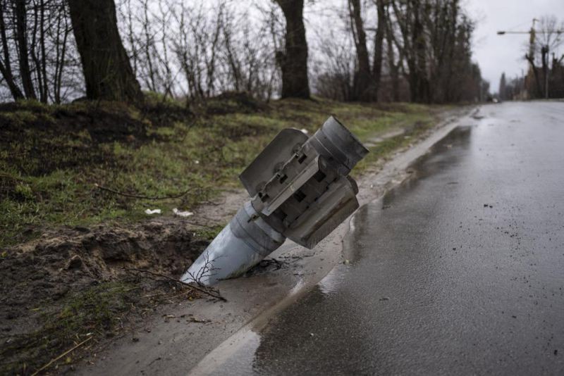 A rocket is buried in the ground in Bucha, Ukraine, Sunday, April 3, 2022. Ukrainian troops are finding brutalized bodies and widespread destruction in the suburbs of Kyiv, sparking new calls for a war crimes investigation and sanctions against Russia. (AP Photo)
