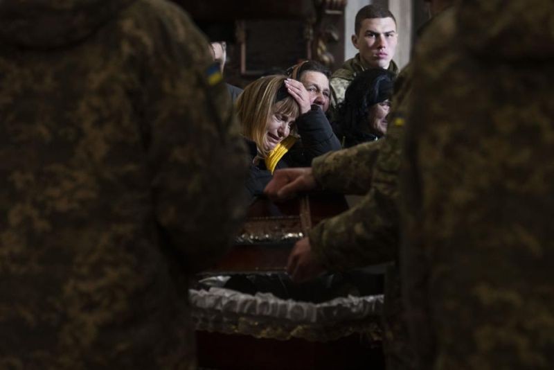 The wife of 44-year-old soldier Tereshko Volodymyr, centre, reacts, during his funeral ceremony, after he was killed in action, at the Holy Apostles Peter and Paul Church, in Lviv, western Ukraine on April 4. (AP Photo)