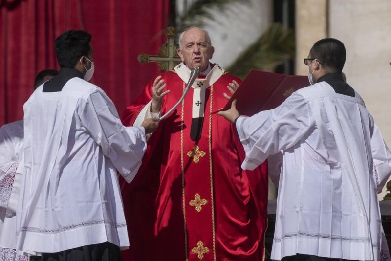 Pope Francis celebrates Palm Sunday Mass in St. Peter's Square at the Vatican, Sunday, April 10, 2022. The Roman Catholic Church enters Holy Week, retracing the story of the crucifixion of Jesus and his resurrection three days later on Easter Sunday. (AP Photo)