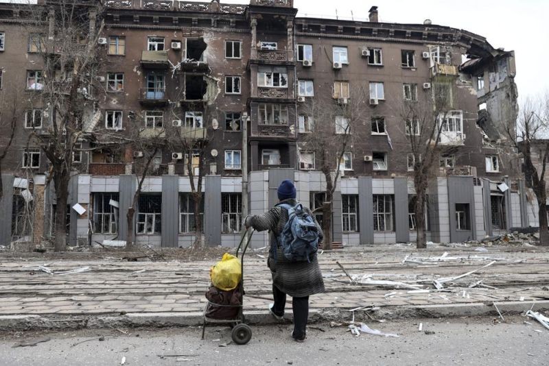 A local resident looks at an apartment building damaged during a heavy fighting near the Illich Iron & Steel Works Metallurgical Plant, the second largest metallurgical enterprise in Ukraine, in an area controlled by Russian-backed separatist forces in Mariupol, Ukraine on April 16. Mariupol, a strategic port on the Sea of Azov, has been besieged by Russian troops and forces from self-proclaimed separatist areas in eastern Ukraine for more than six weeks. (AP Photo)
