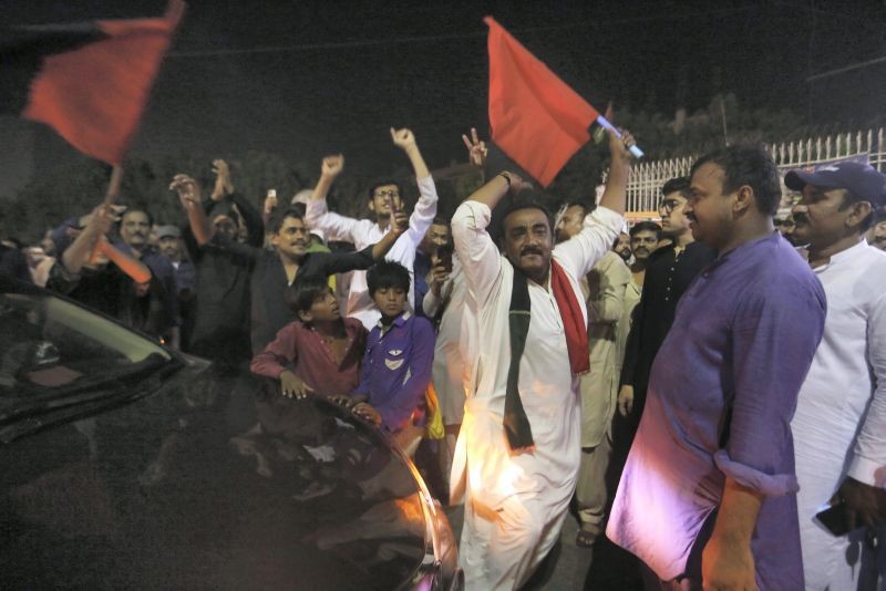 Supporters of an opposition party celebrate the success of a no-confidence vote against Prime Minister Imran Khan, in Karachi, Pakistan on April 10, 2022. Pakistan's political opposition ousted the country's embattled prime minister in a no confidence vote on Saturday, which they won after several of Khan's allies and a key coalition party deserted him. (AP/PTI Photo)