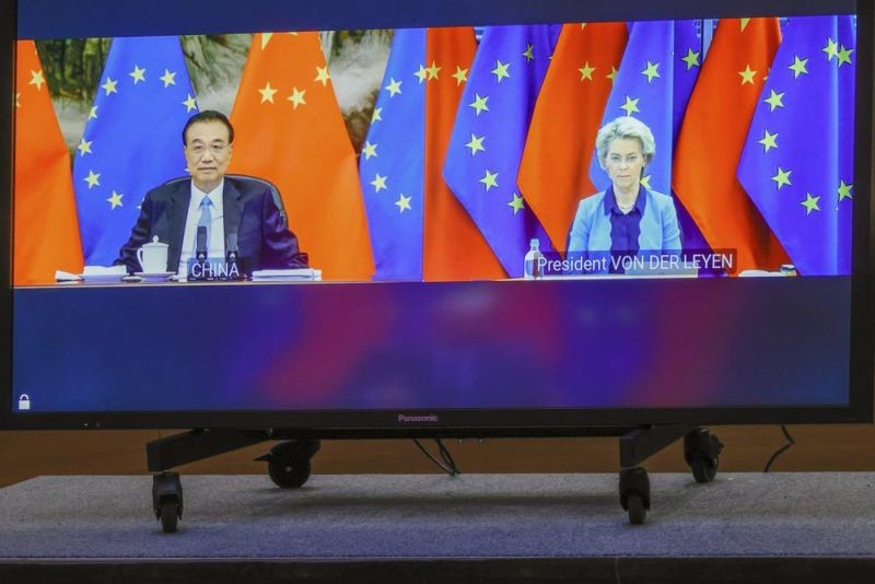 Chinese Premier Li Keqiang, left, and European Commission President Ursula von der Leyen speak via video-conference with European Council President Charles Michel, and European Union foreign policy chief Josep Borrell during an EU China summit at the European Council building in Brussels, Friday, April 1, 2022. (AP Photo)