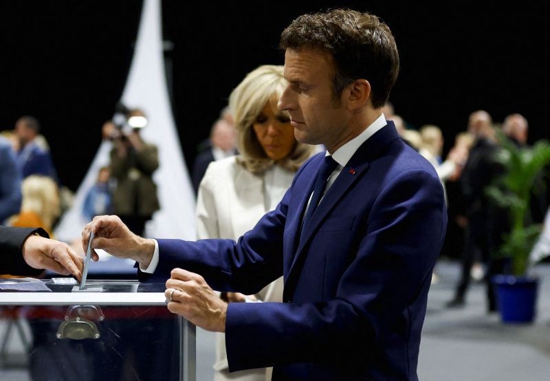 French President and centrist candidate for reelection Emmanuel Macron casts his ballot at a polling station in Le Touquet, northern France on April 24. (AP/PTI Photo)