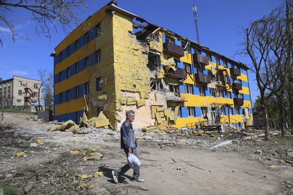 Mariupol: A local resident walks past a destroyed building in Mariupol, in territory under the government of the Donetsk People's Republic, eastern Ukraine, Friday, April 29, 2022. AP/PTI(