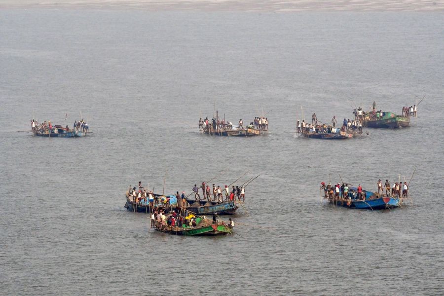Patna: People are allegedly engaged in sand mining activities in the river Ganga despite a ban by the Bihar government, in Patna, Tuesday, April 19, 2022. (PTI Photo)