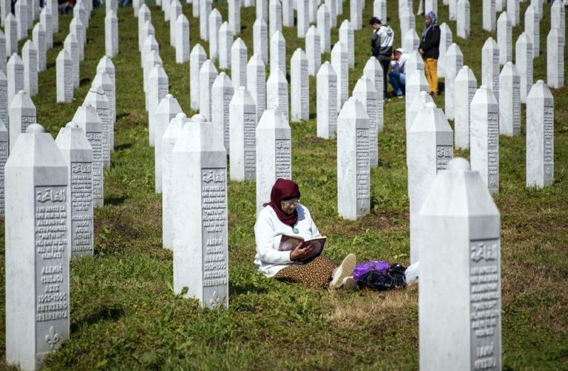 A woman reads a religious text at the memorial cemetery, prior to the funeral in Potocari, near Srebrenica, Bosnia on July 11, 2019. Survivors of war crimes committed during Bosnia’s 1992-95 war say the victims of ongoing human rights abuses in Ukraine should learn from their experience of fighting for justice, but that they must first make peace with the fact that reaching it will inevitably be a lengthy and painful process. (AP File Photo)
