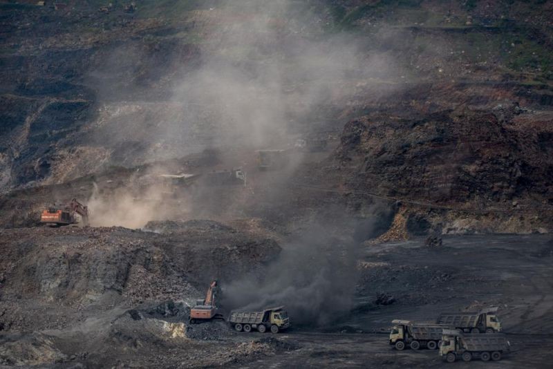 Mining is in progress at an open-cast mine near Dhanbad, an eastern Indian city in Jharkhand state, Sept. 24, 2021. A United Nation-backed panel plans to release a highly anticipated scientific report on Monday, April 4, 2022, on international efforts to curb climate change before global temperatures reach dangerous levels. (AP File Photo)