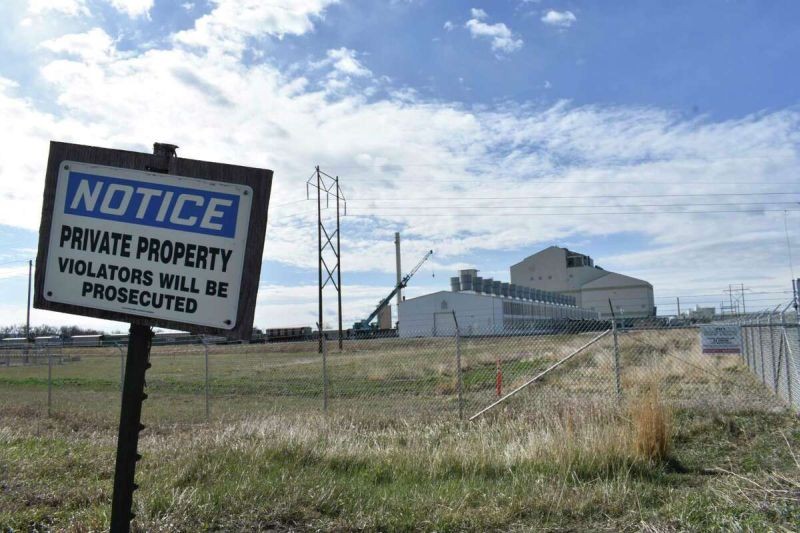 A no trespassing sign is seen near a coal-fired power plant that also houses a cryptocurrency "mining" operation that relies on the plant's energy, on April 20, 2022, in Hardin, Mont. Marathon Digital Holdings has thousands of computers on the site and is planning to relocate to Texas to use power from a wind farm. (AP Photo/Matthew Brown)