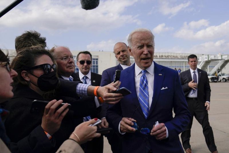 President Joe Biden speaks to reporters before boarding Air Force One at Des Moines International Airport, in Des Moines Iowa, Tuesday, April 12, 2022, en route to Washington. Biden said that Russia's war in Ukraine amounted to a "genocide," accusing President Vladimir Putin of trying to "wipe out the idea of even being a Ukrainian."(AP Photo)