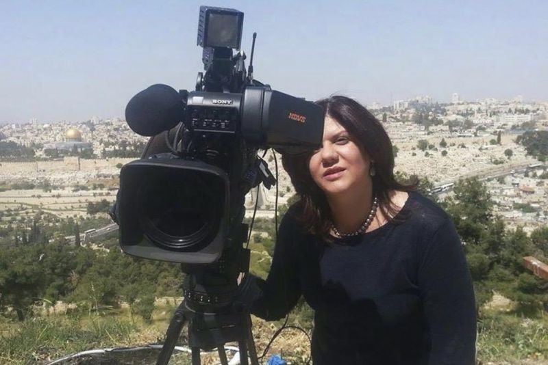 In this undated photo provided by Al Jazeera Media Network, Shireen Abu Akleh, a journalist for Al Jazeera network, stands next to a TV camera in an area where the Dome of the Rock shrine at Al-Aqsa Mosque in the Old City of Jerusalem is seen at left in the background. Abu Akleh, a well-known Palestinian female reporter for the broadcaster's Arabic language channel, was shot and killed while covering an Israeli raid in the occupied West Bank town of Jenin early Wednesday, May 11, 2022. (AP File Photo)