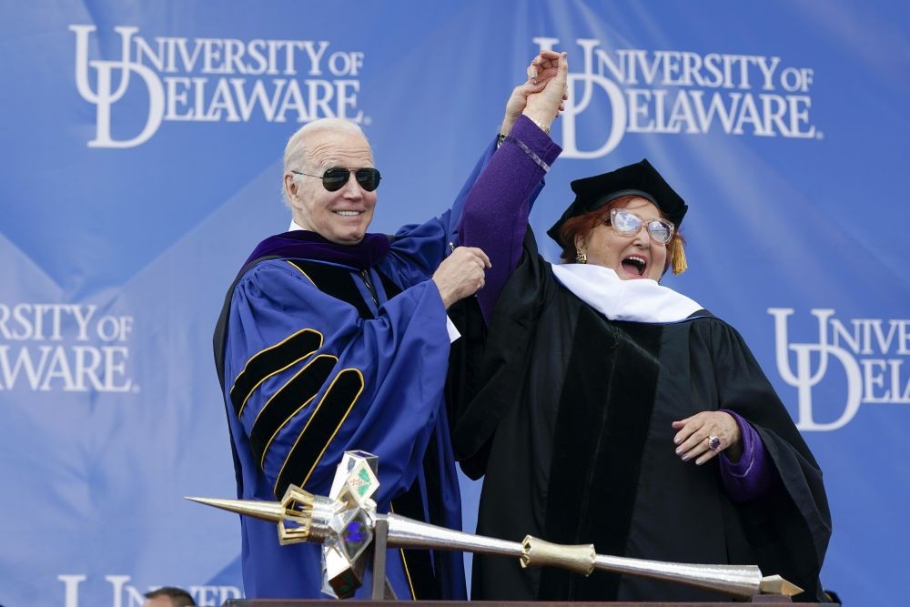 President Joe Biden holds up the hand of honorary degree recipient Tatiana Copeland during the University of Delaware Class of 2022 commencement ceremony in Newark, Del., Saturday, May 28, 2022. (AP Photo/PTI)