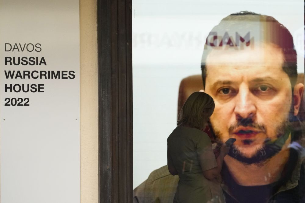 Ukrainian President Volodymyr Zelenskyy speaks on a screen inside a so-called Russian War Crimes House alongside the World Economy Forum in Davos, Switzerland, Sunday, May 22, 2022. An exhibition with pictures documenting suspected Russian war crimes in the Ukrainian war are to be shown in the house. The annual meeting of the World Economy Forum is taking place in Davos from May. 22 until May. 26, 2022.AP/PTI(
