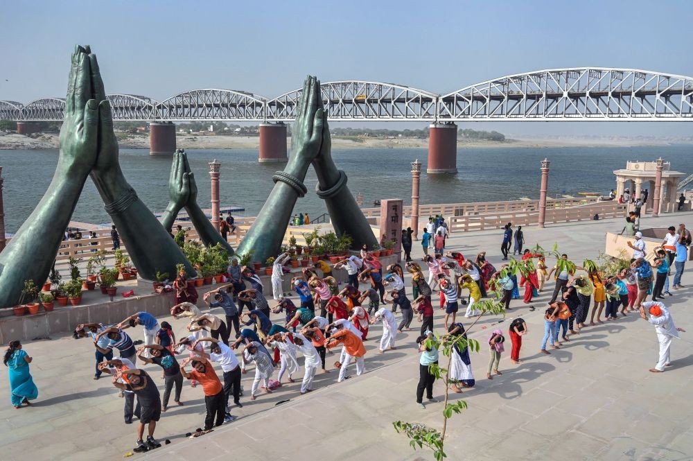 Varanasi: People participate in a yoga session organised at Namo Ghat, in Varanasi, Sunday, May 22, 2022. (PTI Photo)(