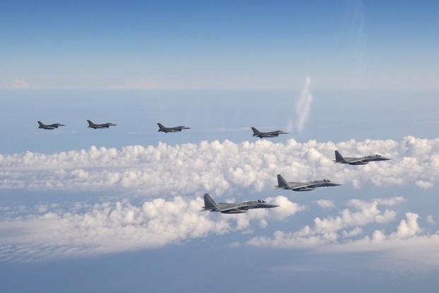 In this photo provided by the Joint Staff of the Japanese Self-Defense Force, three F-15 warplanes of the Japanese Self-Defense Force, front, and four F-16 fighters of the U.S. Armed Forces fly over the Sea of Japan on Wednesday, May 25, 2022. (Joint Staff of the Japanese Self-Defense Force via AP)