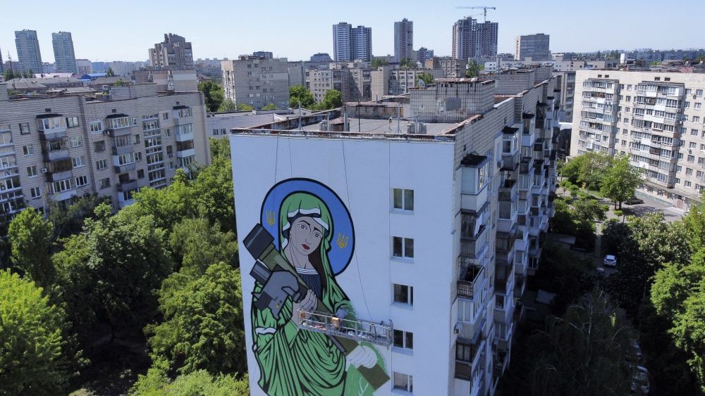 A worker paints a "Saint Javelin", a Virgin Mary holding an American-made anti-tank missile, in Kyiv, Ukraine, Tuesday, May 24, 2022. AP/PTI