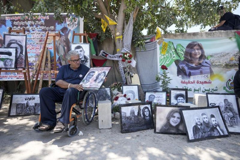 Palestinian journalist Ali Al Samoudi visits a makeshift shrine at the site where veteran Palestinian-American Al Jazeera journalist Shireen Abu Akleh was shot and killed while covering an Israeli raid, in the West Bank city of Jenin on May 19, 2022. Almost two weeks after the death of Abu Akleh, a reconstruction by The Associated Press lends support to assertions from both Palestinian authorities and her colleagues that the bullet that cut her down came from an Israeli gun. (AP File Photo)