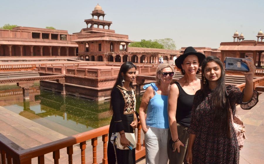 Agra: Tourists click a selfie in front of the Anoop Talab during their visit to the Panch Mahal on a hot summer day, at Fatehpur Sikri in Agra, Friday, May 13, 2022. (PTI Photo)(