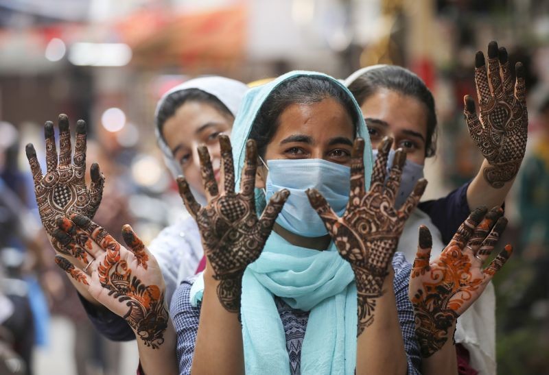 Muslim women show freshly applied henna on their hands, ahead of the 'Eid-ul-Fitr' festival, in Jammu ON May 2. (PTI Photo)