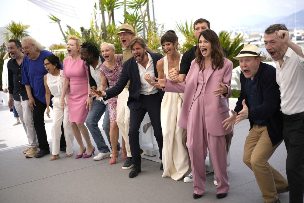 Producer Erik Hemmendorff, from left, Zlatko Buric, Dolly De Leon, Sunnyi Melles, Jean-Christophe Folly, Vicki Berlin, Woody Harrelson, director Ruben Ostlund, Charlbi Dean, Harris Dickinson, Iris Berben, Henrik Dorsin, and producer Philippe Bober pose for photographers at the photo call for the film 'Triangle of Sadness' at the 75th international film festival, Cannes, southern France, Sunday, May 22, 2022. AP/PTI