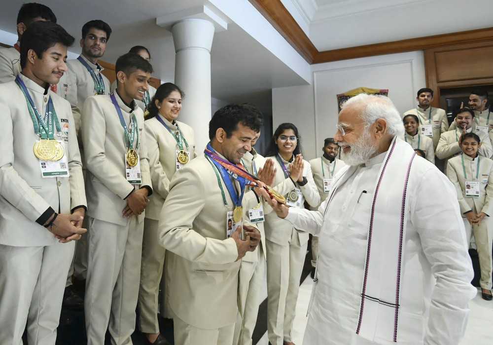 **EDS: HANDOUT PHOTO MADE AVAILABLE FROM PMO ON SATURDAY, MAY 21, 2022.** New Delhi: Prime Minister Narendra Modi during his interaction with Indian Deaflympics contingent, in New Delhi. Union Minister for Youth Affairs & Sports Anurag Thakur is also seen. (PTI Photo)