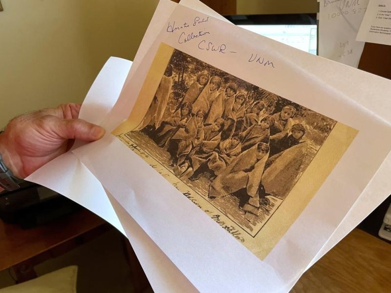 In this July 8, 2021, photo, adjunct history professor and research associate Larry Larrichio holds a copy of a late 19th century photograph of pupils at an Indigenous boarding school in Santa Fe during an interview in Albuquerque, New Mexico. The U.S. Interior Department is expected to release a report Wednesday, May 11, 2022, that it says will begin to uncover the truth about the federal government's past oversight of Native American boarding schools. (AP File Photo)