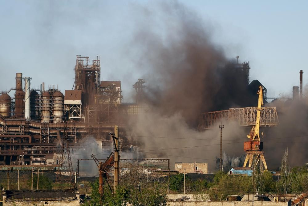 Smoke rises from the Metallurgical Combine Azovstal in Mariupol during shelling, in Mariupol, in territory under the government of the Donetsk People's Republic, eastern Ukraine, Saturday, May 7, 2022. (AP Photo/Alexei Alexandrov)