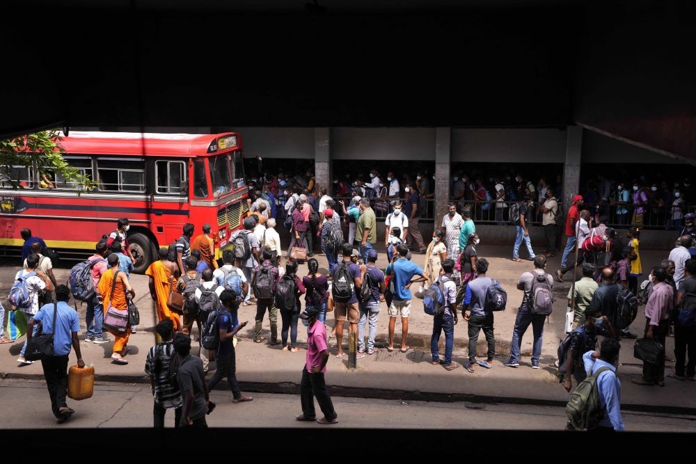 Colombo: Stranded Sri Lankans wait at a bus terminus during a relaxation in a nationwide curfew that began Monday evening in Colombo, Sri Lanka, Thursday, May 12, 2022. Sri Lanka's president on Wednesday promised to appoint a new prime minister, empower the Parliament and abolish the all-powerful executive presidential system as reforms to stabilize the country engulfed in a political crisis and violence triggered by the worst economic crises in memory.AP/PTI