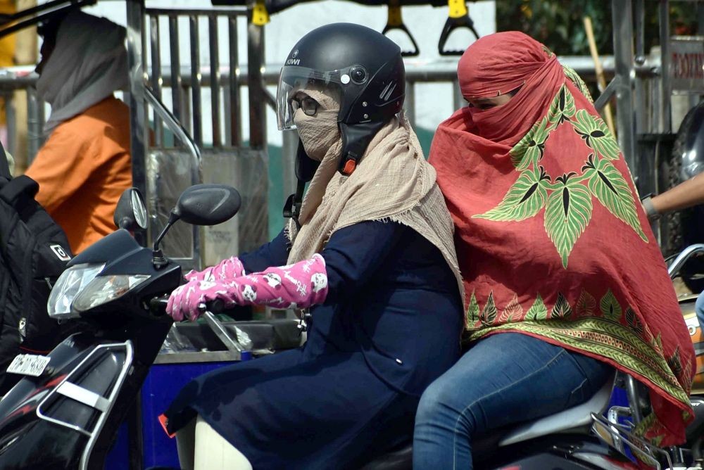Prayagraj: Women cover themselves with scarves to avoid the scorching heat on a hot summer day, in Prayagraj, Monday, May 16, 2022. (PTI Photo)