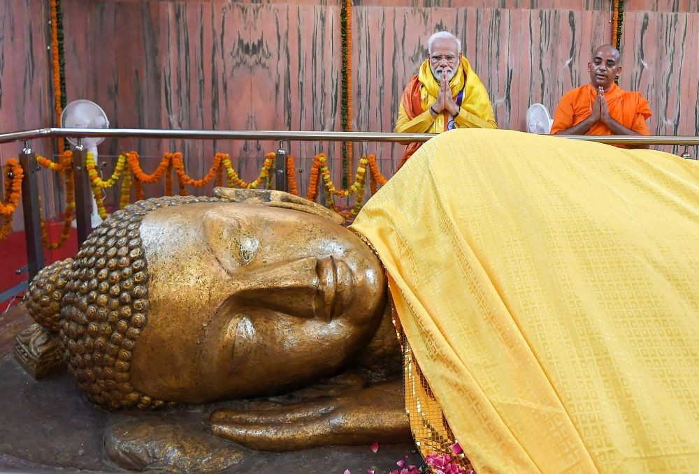 **EDS: HANDOUT PHOTO MADE AVAILABLE FROM PIB ON MONDAY, MAY 16, 2022** Kushinagar: Prime Minister Narendra Modi offers prayers at the Mahaparinirvana Stupa, in Kushinagar. (PTI Photo)