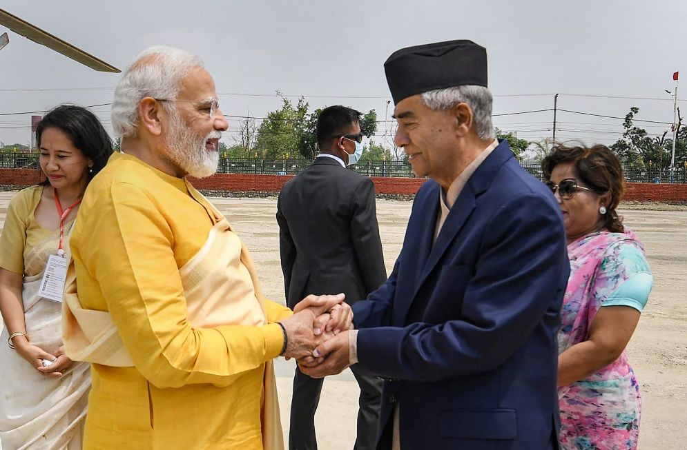 **EDS: TWITTER IMAGE POSTED BY @narendramodi ON MONDAY, MAY 16, 2022** Lumbini: Prime Minister Narendra Modi being greeted by Nepal PM Sher Bahadur Deuba as he arrives in Lumbini, the birth place of Lord Buddha. (PTI Photo)