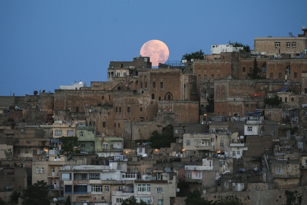 Mardin: A full moon rises above the historical city center of Mardin, famous with its stone houses, in southeastern Turkey, early Monday, May 16, 2022. People in the Americas, Europe and Africa will see the total lunar eclipse during the night of May 15-16. AP/PTI