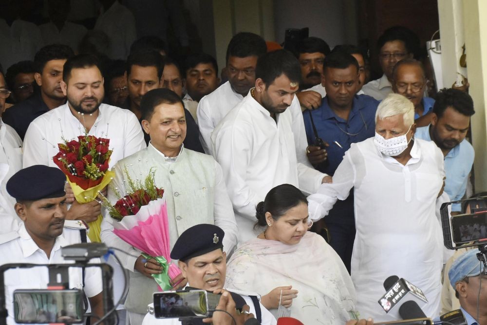 **EDS: RPT, ADDS DETAILS** Patna: RJD Chief Lalu Prasad Yadav with party candidates Misa Bharti and Faiyaz Ahmad leave after filing their nomination papers for Rajya Sabha, at Vidhan Sabha in Patna, Friday, May 26, 2022. (PTI Photo)