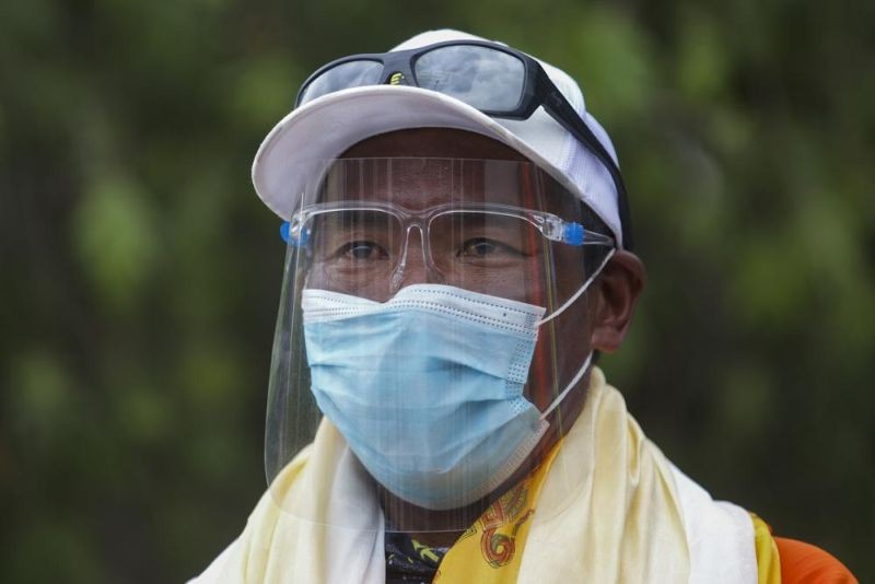 Veteran Sherpa guide Kami Rita who returned from the mountains on a helicopter arrives at the airport in Kathmandu, Nepal on May 25, 2021. The experienced Nepalese Sherpa guide scaled Mount Everest for the 26th time breaking his own record for the most climbs of the world's highest peak, expedition organizers said Sunday, May 8, 2022. (AP File Photos)