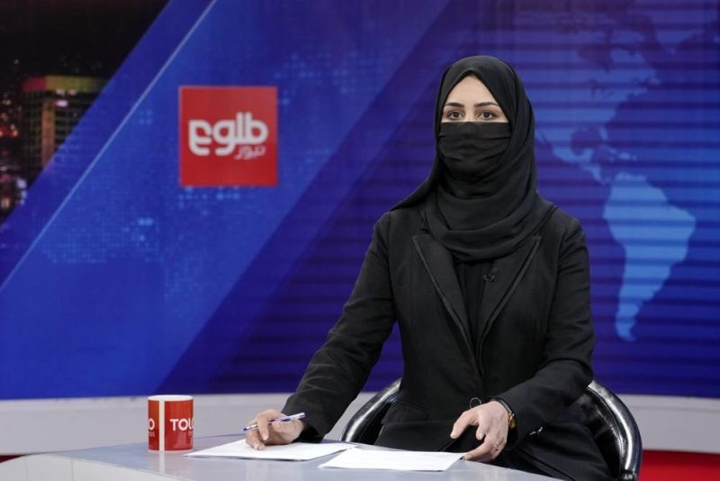 Khatereh Ahmadi a TV anchor wears a face covering as she reads the news on TOLO NEWS, in Kabul, Afghanistan on May 22, 2022. Afghanistan's Taliban rulers have begun enforcing an order requiring all female TV news anchors in the country to cover their faces while on-air. The move Sunday is part of a hard-line shift drawing condemnation from rights activists. (AP Photo)