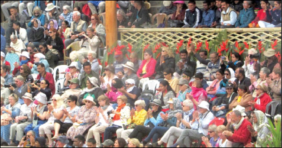 Tourists are seen enjoying cultural display (not seen) at the Hornbill Festival at Kisama. Nagaland Government has claimed that it is promoting and encouraging the development of home stay and paying guests accommodation in most areas of Nagaland to accommodate the growing tourist inflow to the state. (Morung file photo)