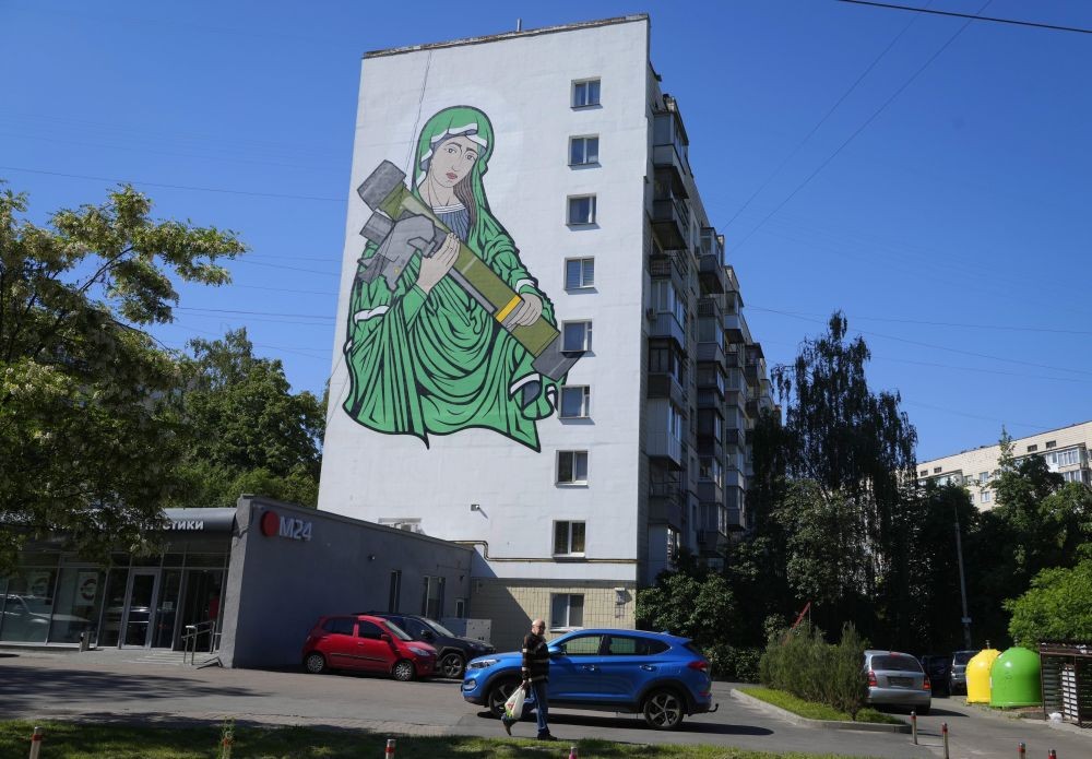 A mural depicts an image known as "Saint Javelina"- Virgin Mary cradling a US-made FGM-148 anti-tank weapon Javelin - on a living house wall in Kyiv, Ukraine, Monday, June 6, 2022. These missiles are among the arms being sent by Western allies to Ukrainian forces to aid in their fight against the Russian invaders. Javelin is widely considered a symbol of Ukraine's defence. AP/PTI