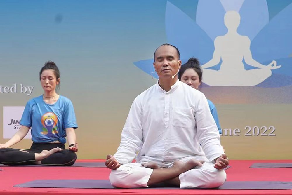 **EDS: IMAGE POSTED BY @EOIBeijing** Beijing: Guru N.K. Singh leads a yoga session, ahead of the International Day of Yoga, in Beijing, Saturday, June 18, 2022. (PTI Photo)