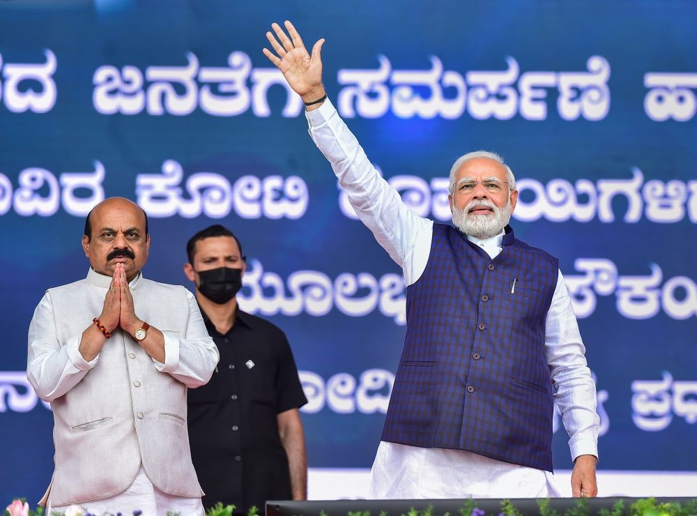 Bengaluru: Prime Minister Narendra Modi waves towards supporters during the launch of railway and road projects, in Bengaluru, Monday, June 20, 2022. Karnataka CM Basavaraj Bommai is also seen. (PTI Photo/Shailendra Bhojak)