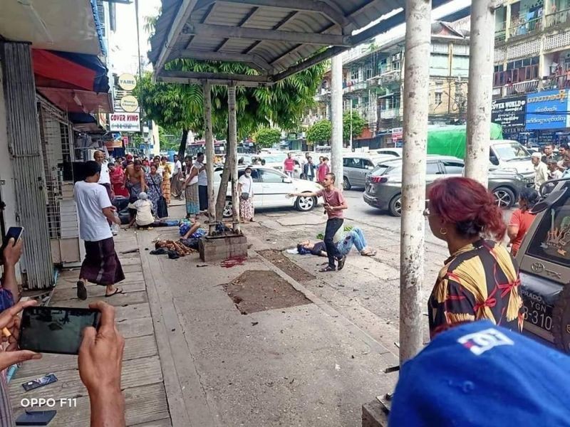 In this photo provided by the information office of Myanmar's military, four injured people can be seen lying on the pavement after an explosion at a bus stop in downtown Yangon on May 31, 2022. One person was killed and nine wounded when what authorities described as a handmade bomb exploded. The military and its foes blamed each other for the blast. (AP Photo)