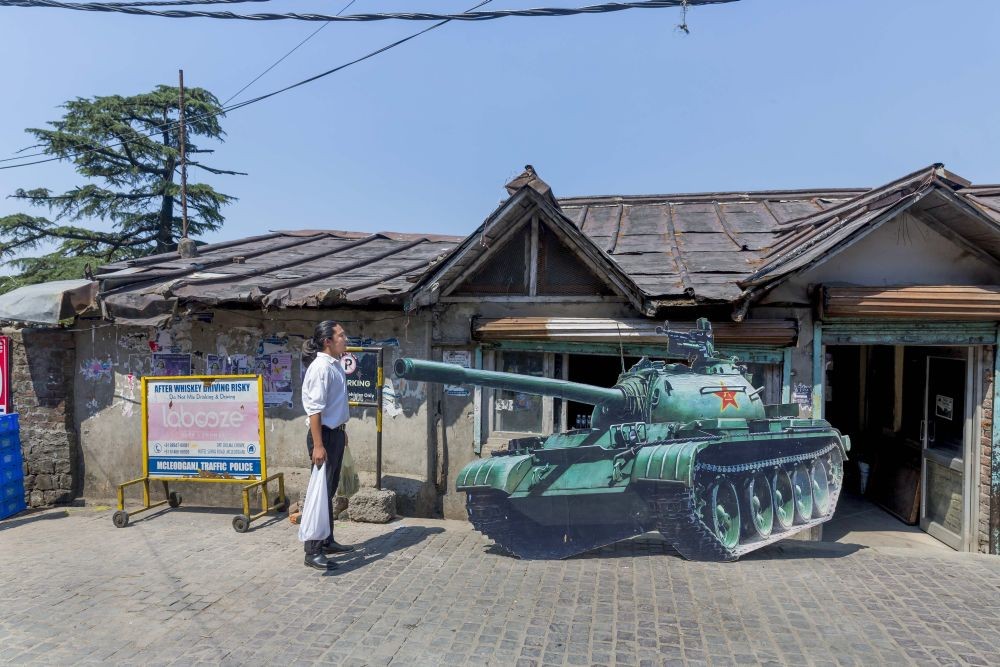 Dharamsala: A tibetan-in-exile stands near a cut-out of a tank to mark 33 years of the Tiananmen Square massacre, at McLeodganj near Dharamsala, Saturday, June 4, 2022. (PTI Photo)