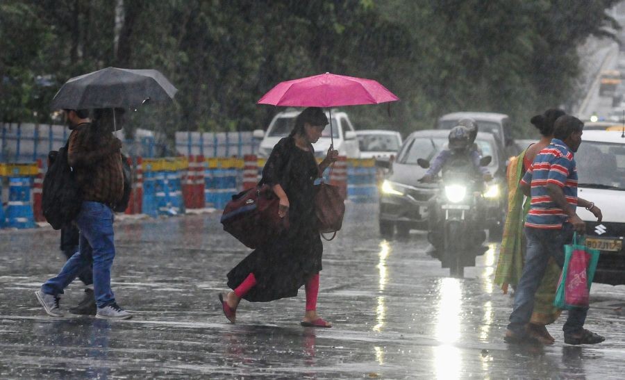 Kolkata: Pedestrians cross a road during rains, in Kolkata, Friday, June 17, 2022. (PTI Photo)