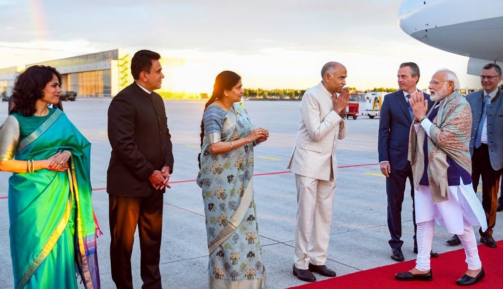 **EDS: HANDOUT PHOTO MADE AVAILABLE FROM PIB ON SUNDAY, JUNE 26, 2022** Munich: Prime Minister Narendra Modi being received by officials, upon his arrival in Munich, Germany, Sunday, June 26, 2022. PM Modi will attend the 48th G7 summit. (PTI Photo)