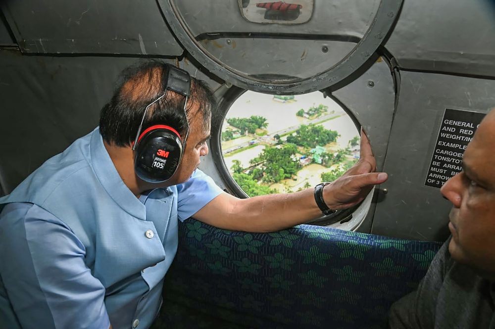 **EDS: TWITTER IMAGE POSTED BY @himantabiswa ON THURSDAY, JUNE 23, 2022** Silchar: Assam Chief Minister Himanta Biswa Sarma conducts an aerial survey of flood-hit Silchar, in Assam. Assam BJP Vice President Rajdeep Roy is also seen. (PTI Photo)
