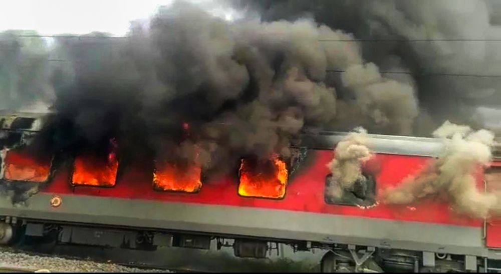 Lakhisarai: Jammu Tawi Guwahati Express train set on fire by a mob in protest against the Centre's 'Agnipath' scheme, in Hajipur, Friday, June 17, 2022. (PTI Photo)
