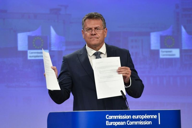 European Commissioner for Inter-institutional Relations and Foresight Maros Sefcovic holds up documents as he speaks during a media conference at EU headquarters in Brussels, Wednesday, June 15, 2022. Britain's government on Monday proposed new legislation that would unilaterally rewrite post-Brexit trade rules for Northern Ireland, despite opposition from some U.K. lawmakers and EU officials who say the move violates international law. (AP Photo)