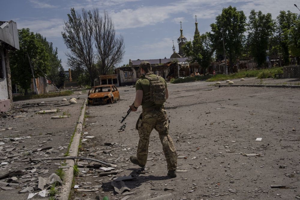 A Ukrainian serviceman patrols a village near the frontline in the Donetsk oblast region, eastern Ukraine, Thursday, June 2, 2022. AP/PTI